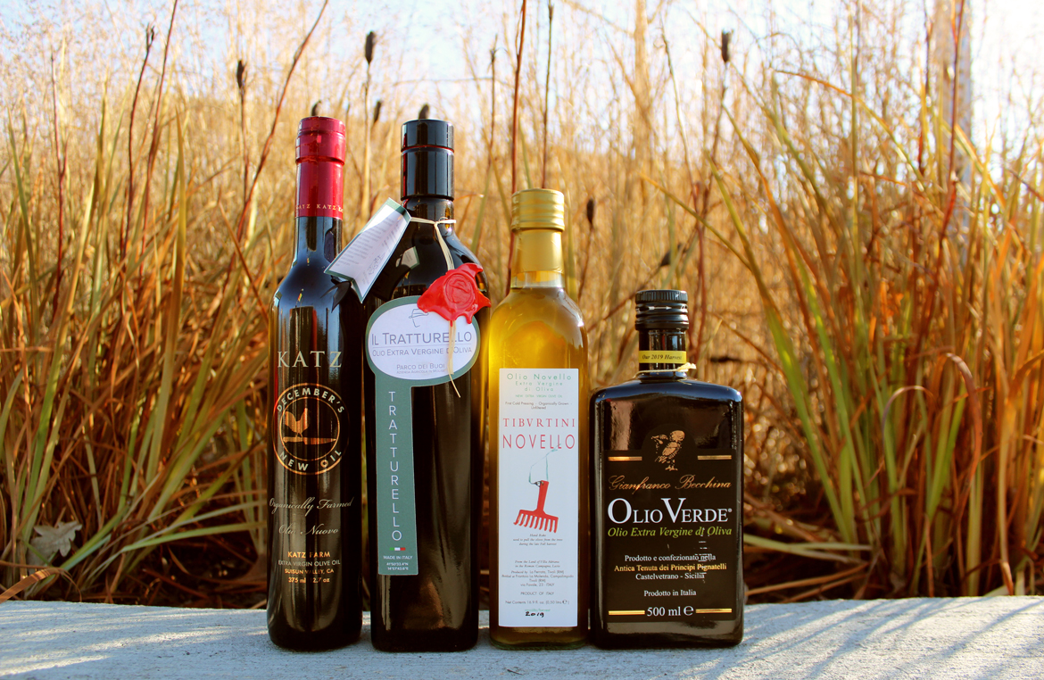 Zingerman's 2019 Olio Nuevo bottles outside in the sunset - New Harvest Olive Oils