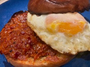 A fried egg sandwich made with 'Nduja, Calabrian style spicy spreadable salumi 