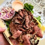 A Neat-o Guide to a Low-Carb and Keto-Friendly Deli Visit An Instagram photo of sliced corned beef and sliced Swiss cheese on a bed of lettuce with small cups of coleslaw and Russian dressing on the side, with a sheet of Zingerman's Deli paper under everything.