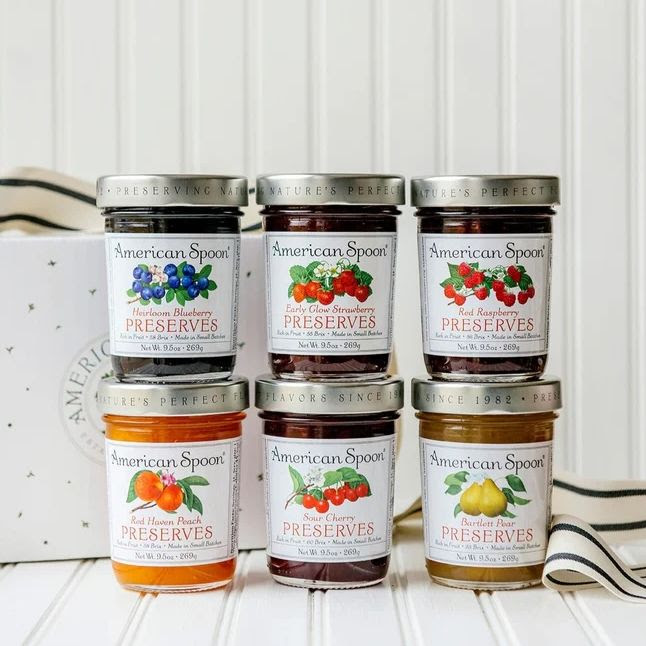 A photo of six jars of different American Spoon preserves, three stacked on top of the other three.
