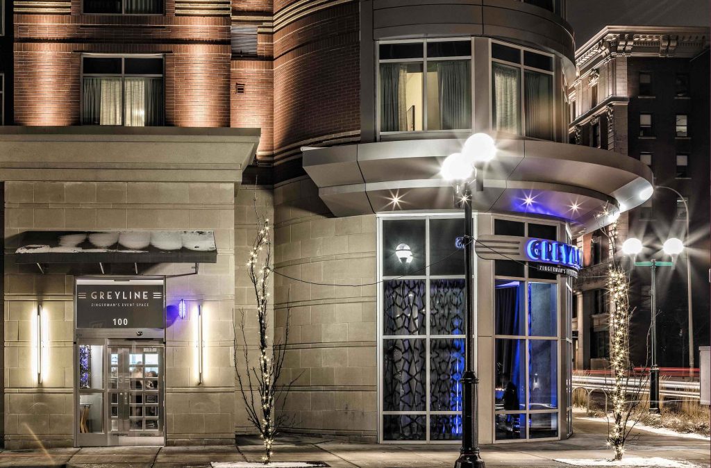 a photo of the exterior of the Greyline with twinkle lights on trees