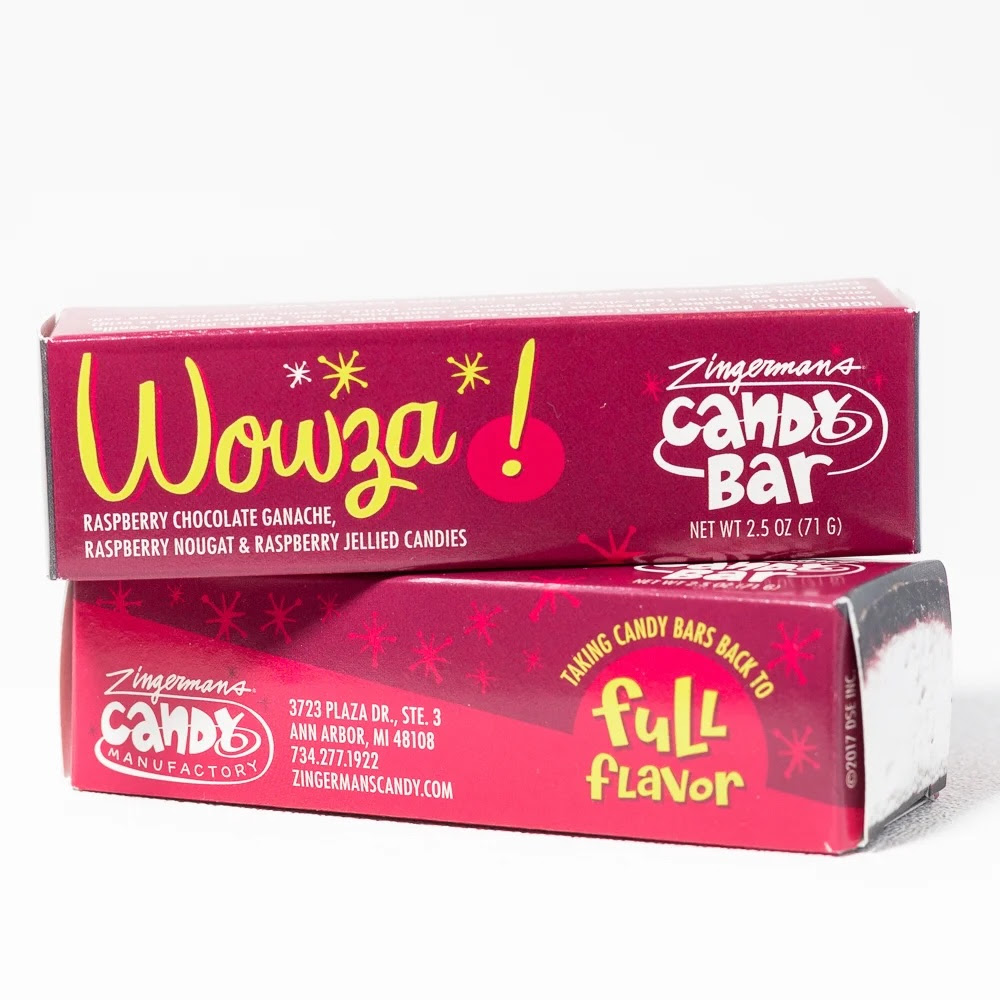 A photo of two Wowza bars in their packaging, one stacked on top of the other. The packages are deep magenta with fun cursive yellow text that says "Wowza!"