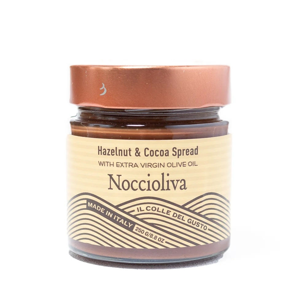 A photo of a jar of Noccioliva. The jar is glass with a copper colored screw-top lid, and a tan label with dark brown text.