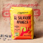 Super Excellent El Salvador Apaneca Coffee A photo of a bag of El Salvador Apaneca beans against a Zingerman's Coffee burlap coffee bean bag background.