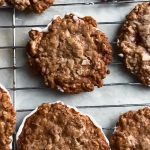 Five Spice Matzo White Chocolate Florentines A top-down photo of a drying rack with the Matzo Florentines resting on it.