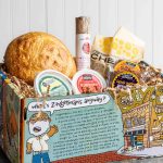 We’re Matt Rodbard’s “Favorite Food Store in the World”! A photo of a Zingerman's Mail Order box filled with Matt's favorites: A sourdough round, a log of Finocchia salami, a cheese bag, Natural Northern Whitefish Pate, Zingerman's Pimento Cheese, and a Magic and Black Magic brownie.