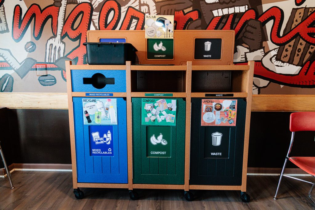 A photo of the Deli's waste stream sorting bins in the upstairs seating area.