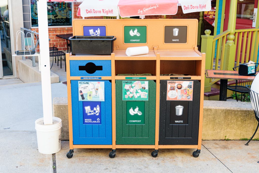 A photo of the Deli's waste stream sorting bins outside on the patio.