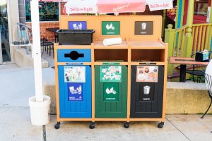 A photo of the Deli's waste stream sorting bins outside on the patio.