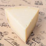 ’Nati Gouda from Urban Stead A photo of a triangular wedge of 'Nati Gouda on a sheet of Deli butcher paper.