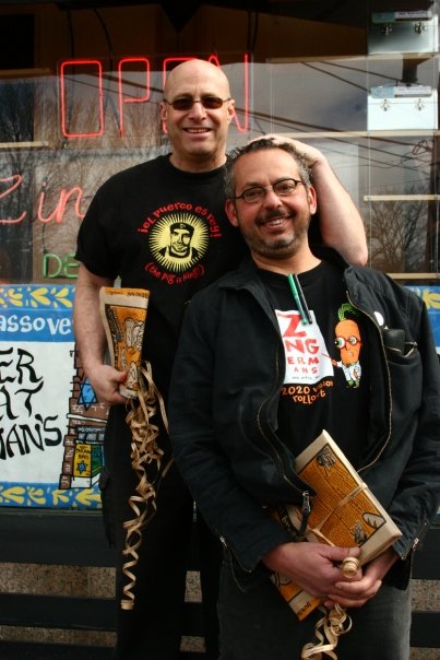 A photo from 2009 of Paul and Ari standing together in front of the Deli.