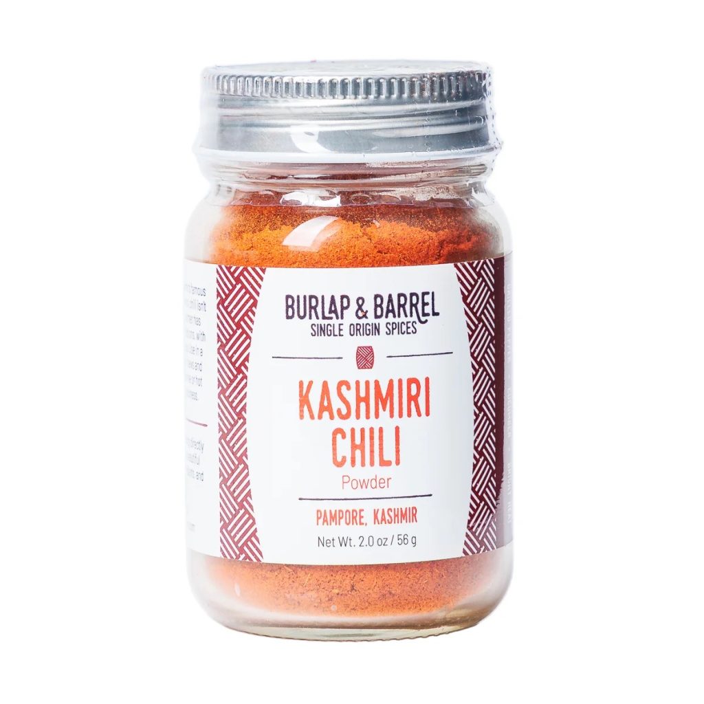 A photo of a small jar of Burlap & Barrel's Kashmiri Chili powder.