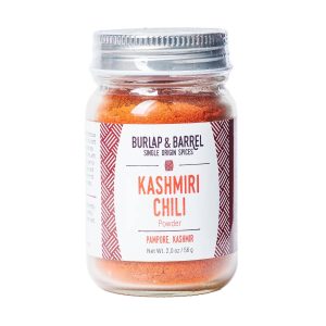 A photo of a small jar of Burlap & Barrel's Kashmiri Chili powder.